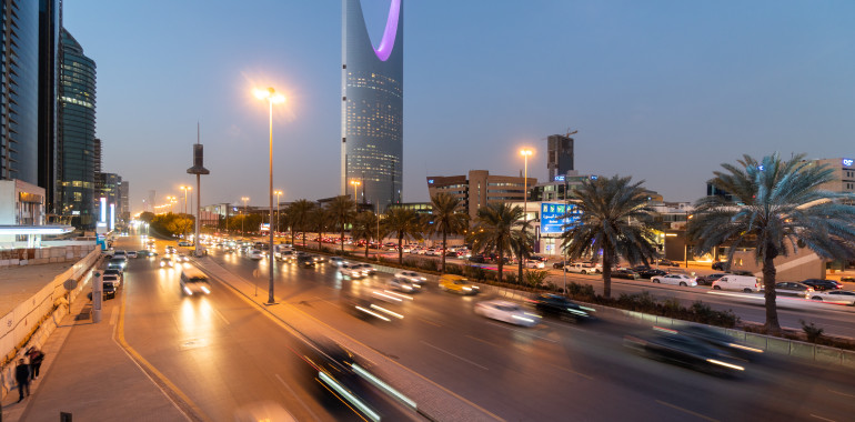 Traffic on the main avenue crossing the modern business and downtown district of Riyadh at sunset in Saudi Arabia capital city